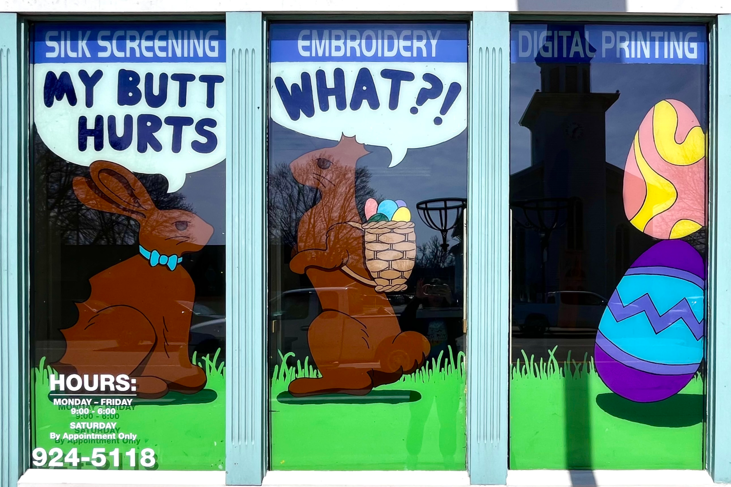 Two chocolate bunnies, one with a bite taken out of its' butt saying, "My butt hurts", and the other with its' ears bitten off saying, "What?!"