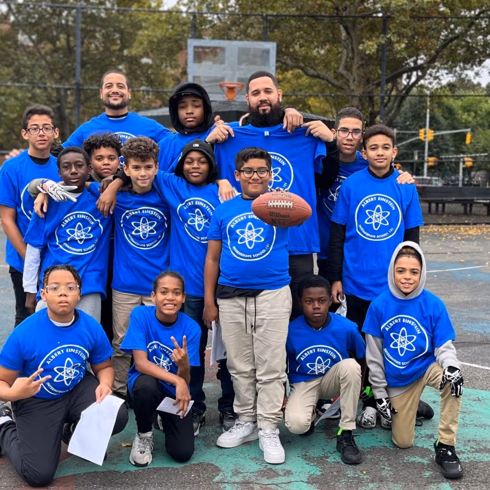 Albert Einstein IS 131 football team and coaches pose outdoors