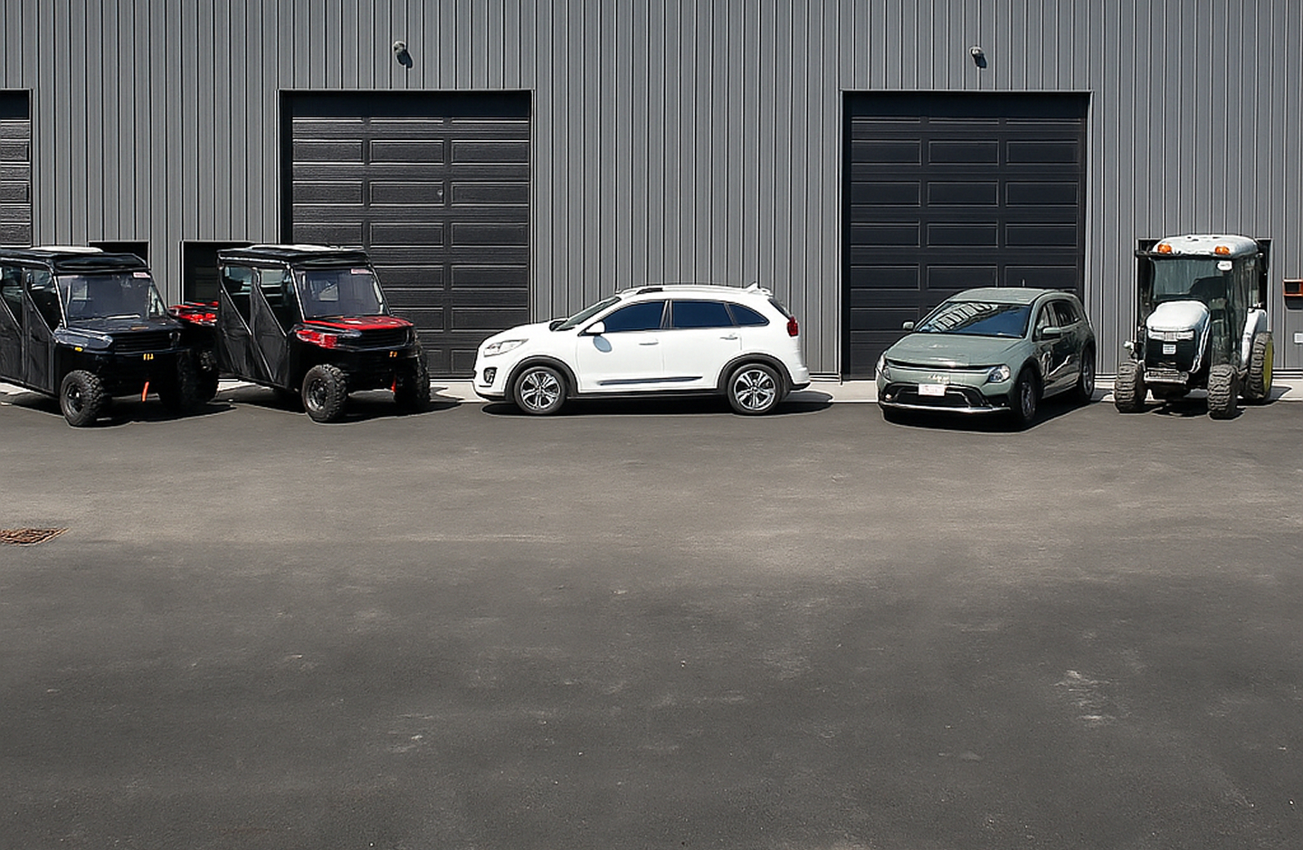 5 cards in front of a large garage