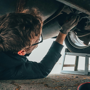 Mechanic working under a car