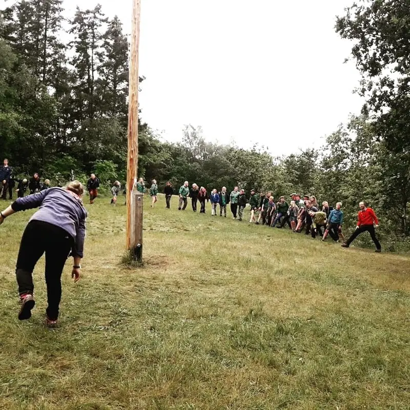 People playing around a flagpole