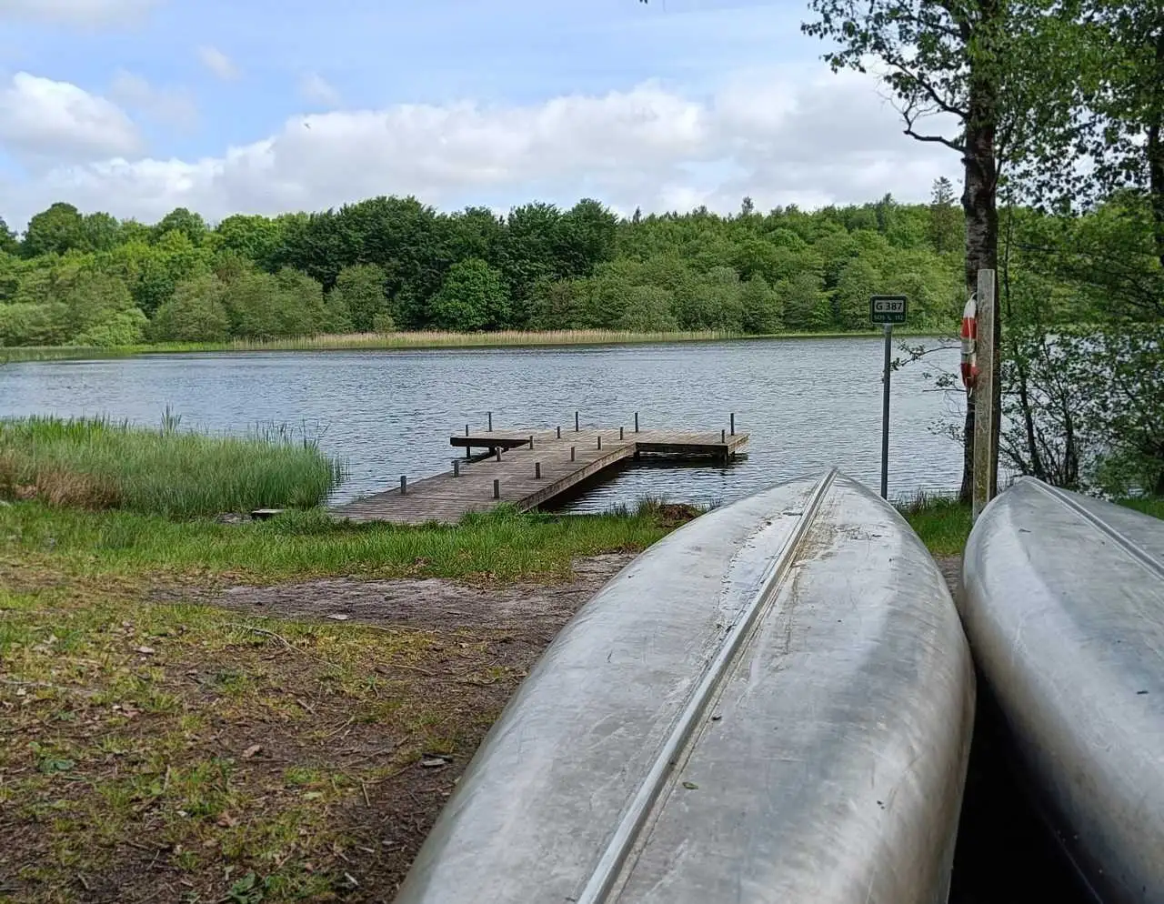A small wooden pier and two canoes