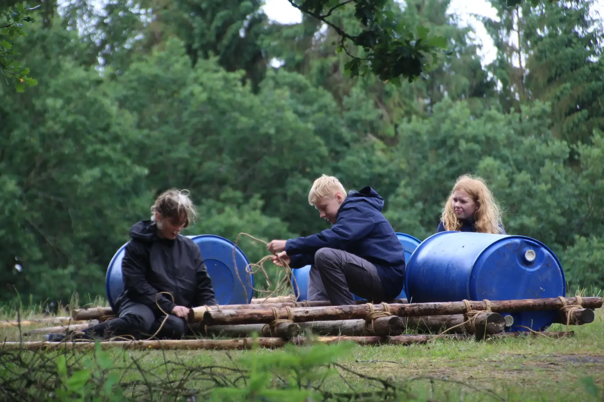 Three kids building a raft