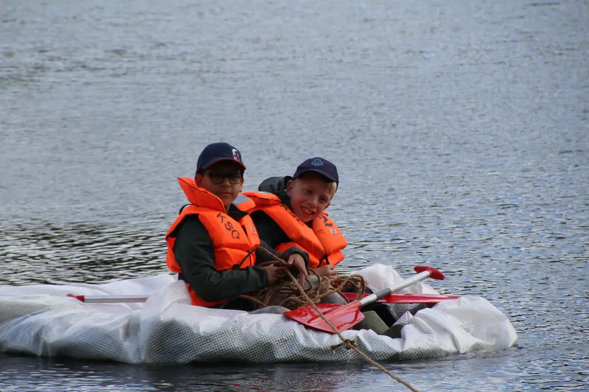 A couple of boys on a makeshift raft