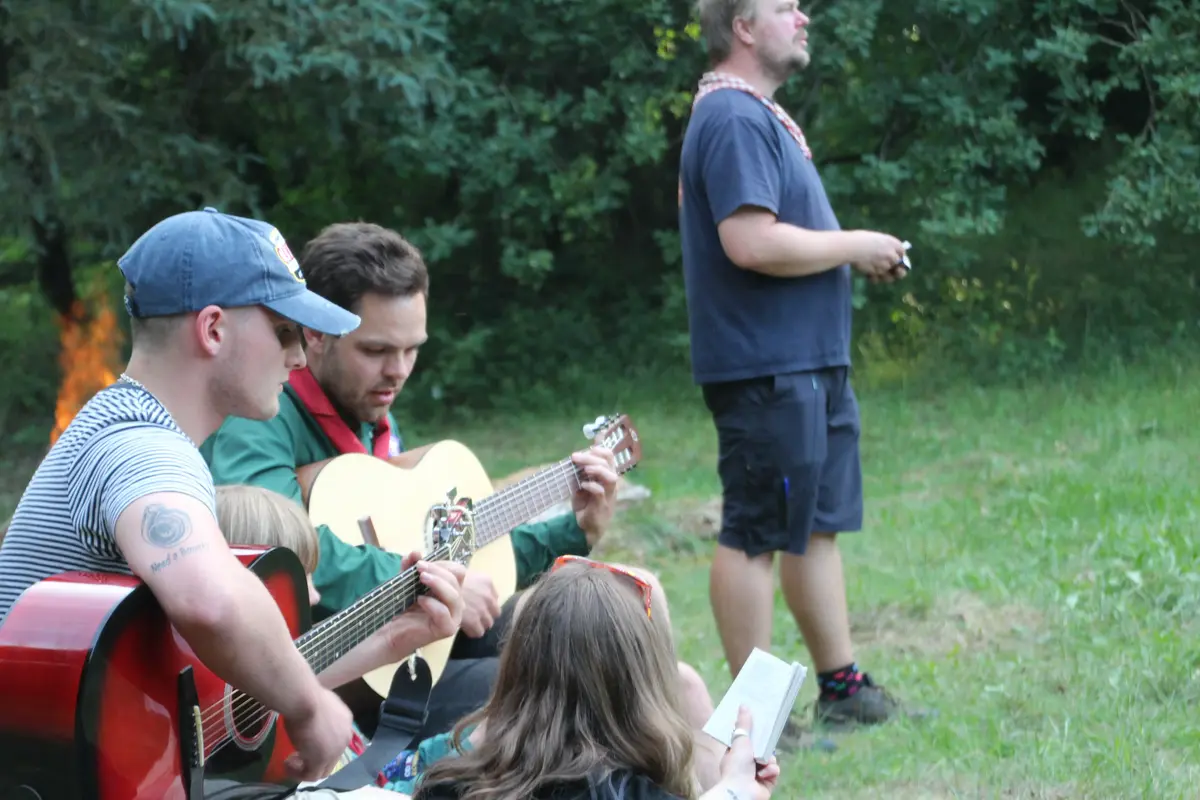 A group of people performing on guitars