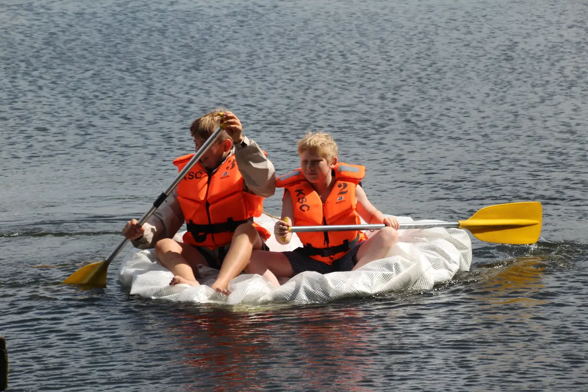 A couple of boys on a makeshift raft