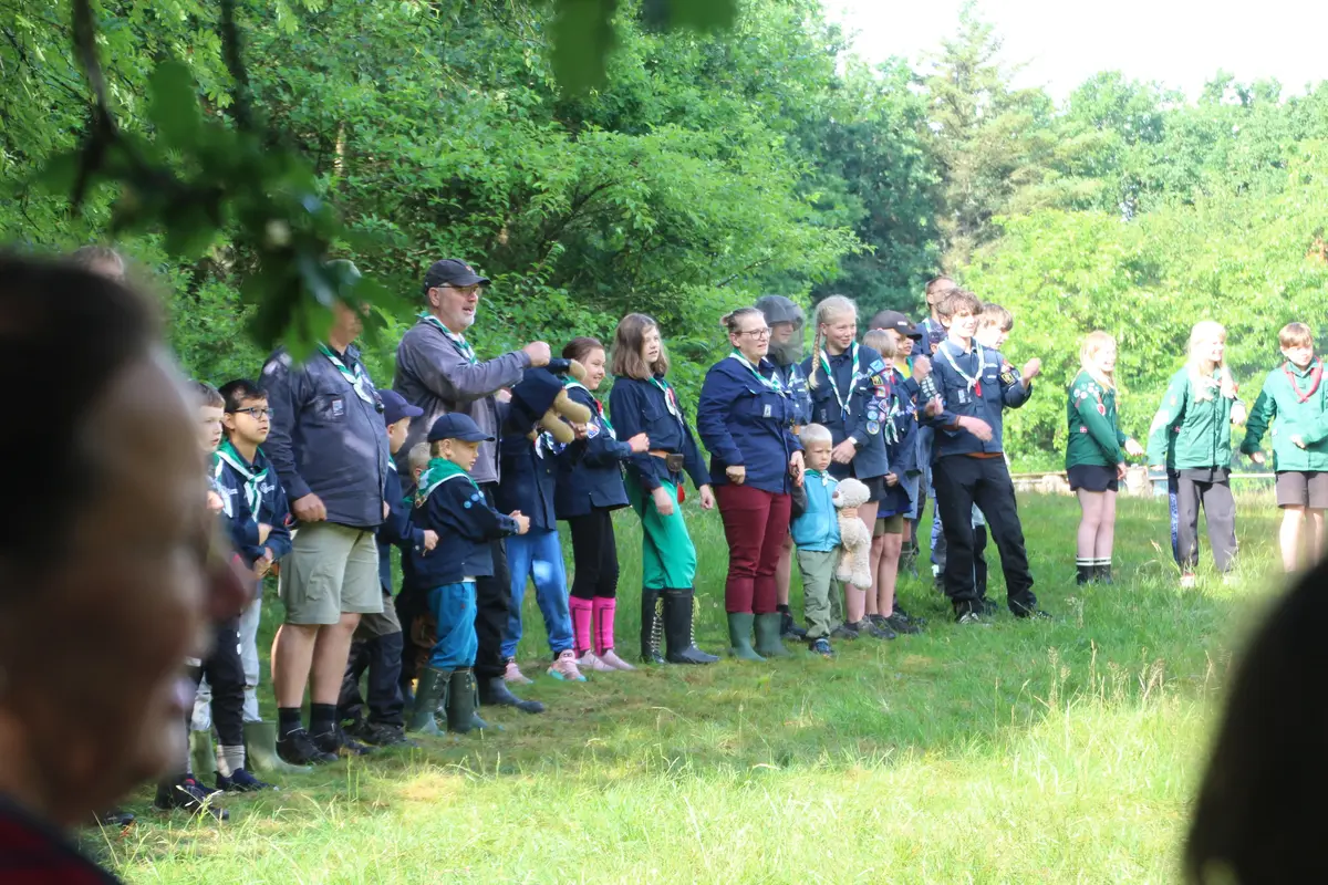 A group of people in a forest clearing