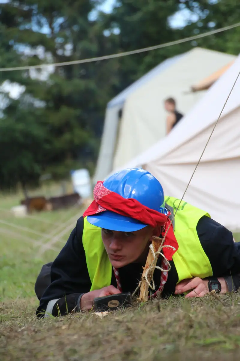 A scout preparing a tent