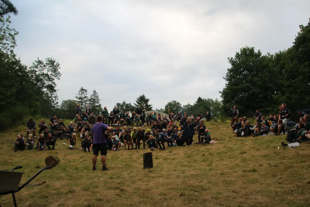A hills with lots of people sitting on it