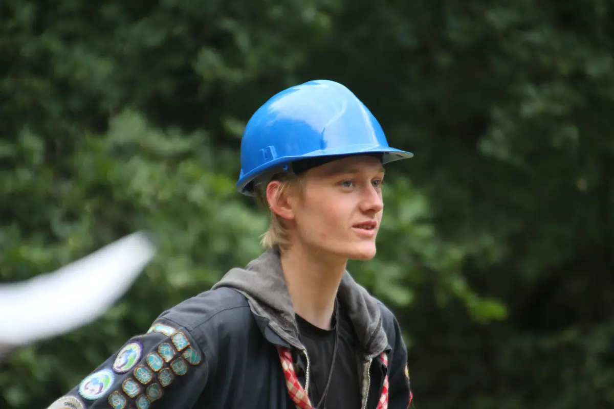 A young guy with a blue hardhat