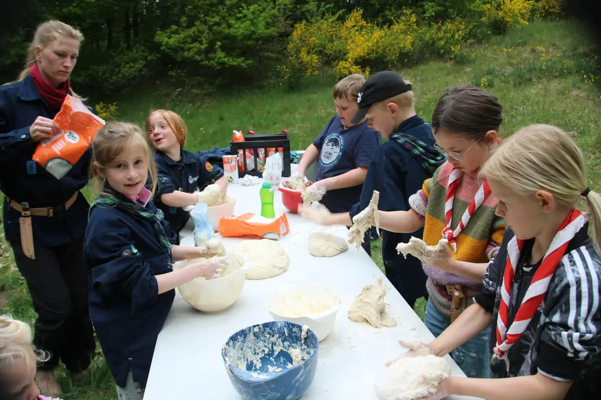 A group of kids making dough