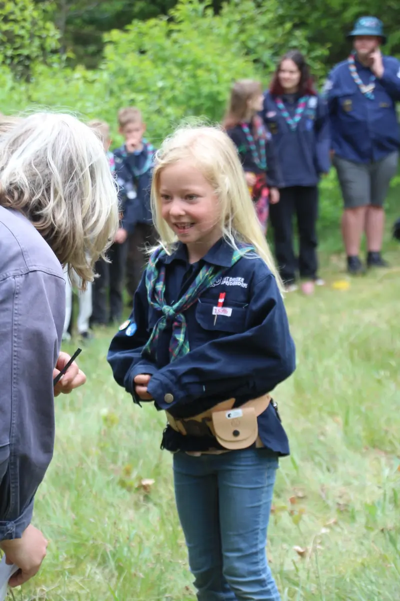 A young girl getting congratulated