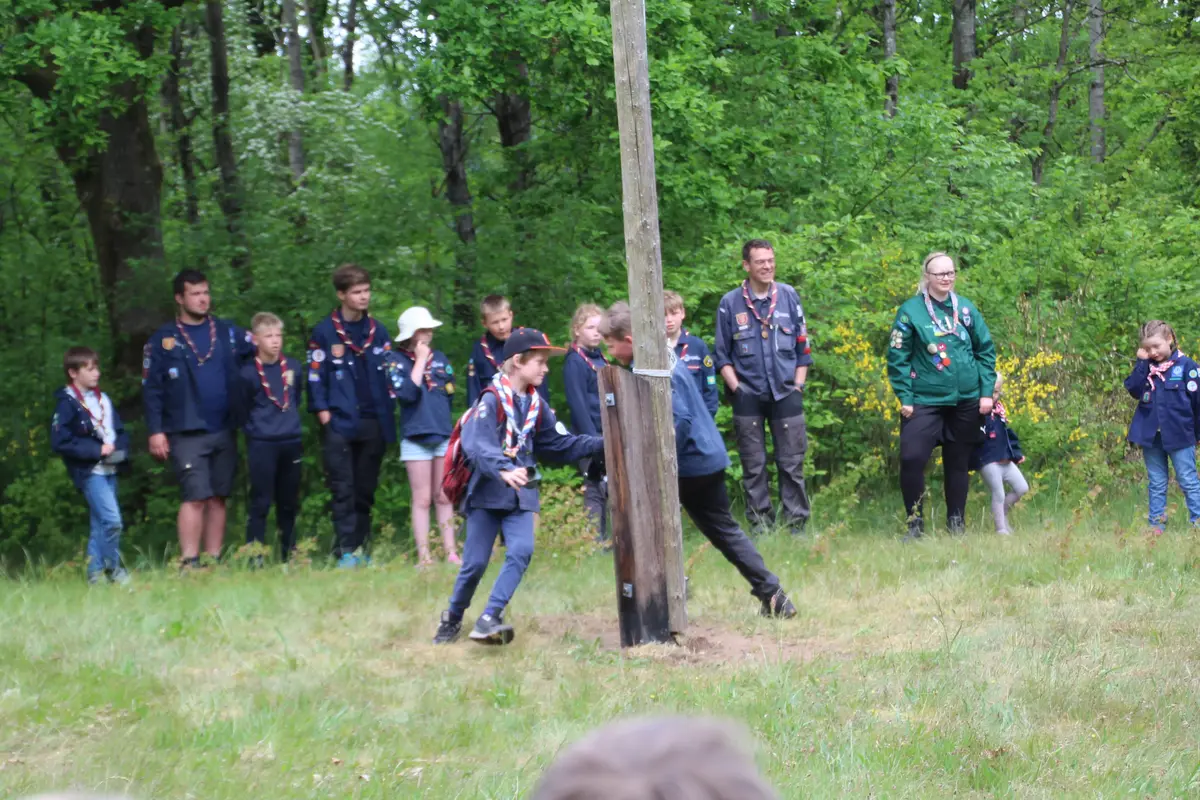 Two kids racing around a flagpole