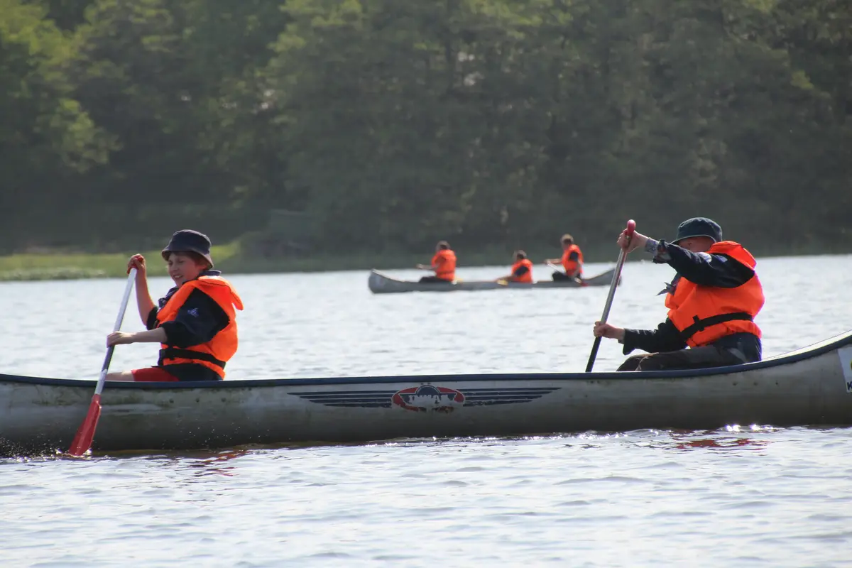 A group of people sailing in a canoe