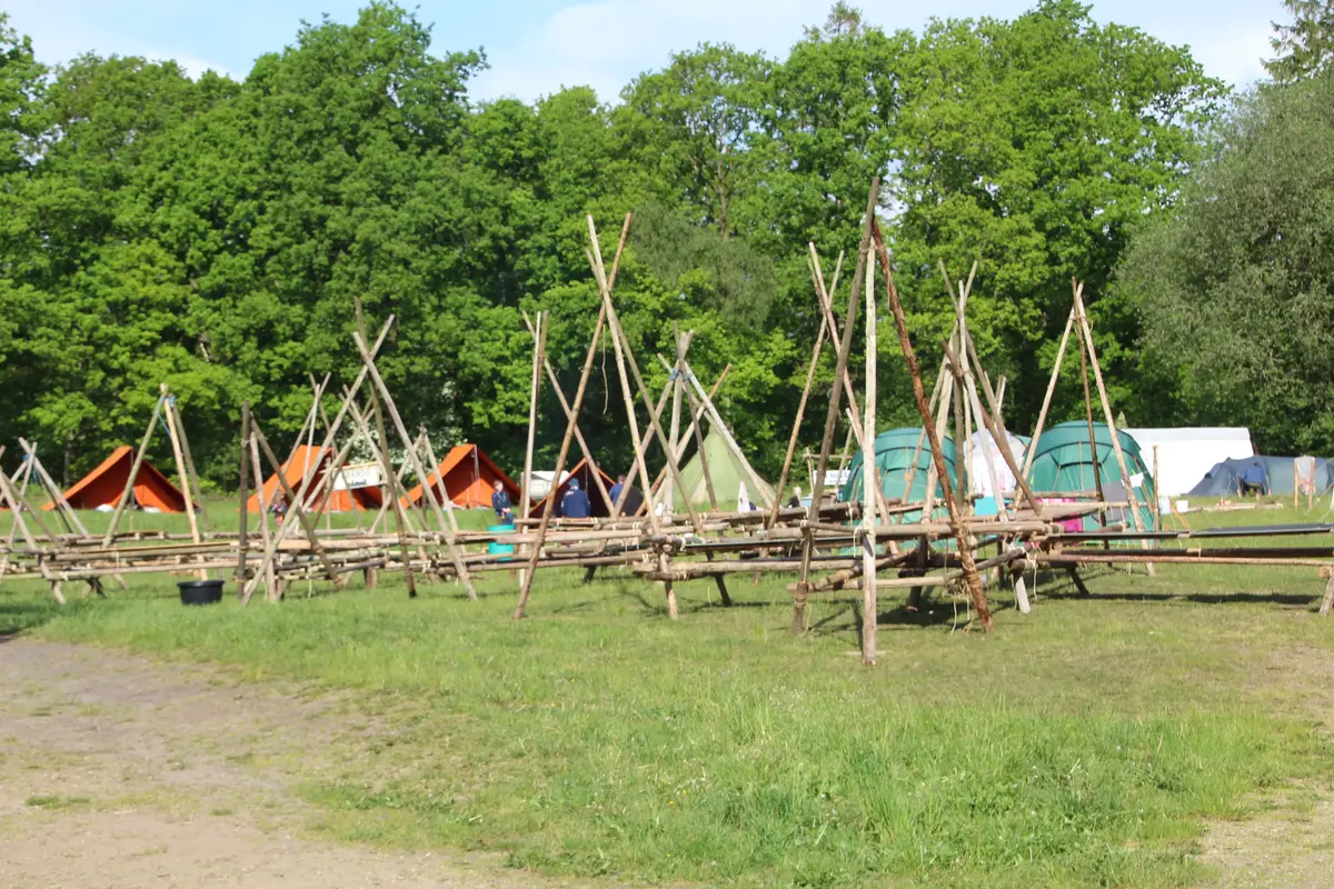 A bunch of wooden structures on a grass field