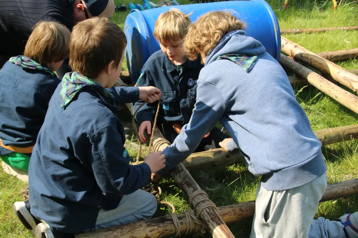 A group of kids tying up a raft