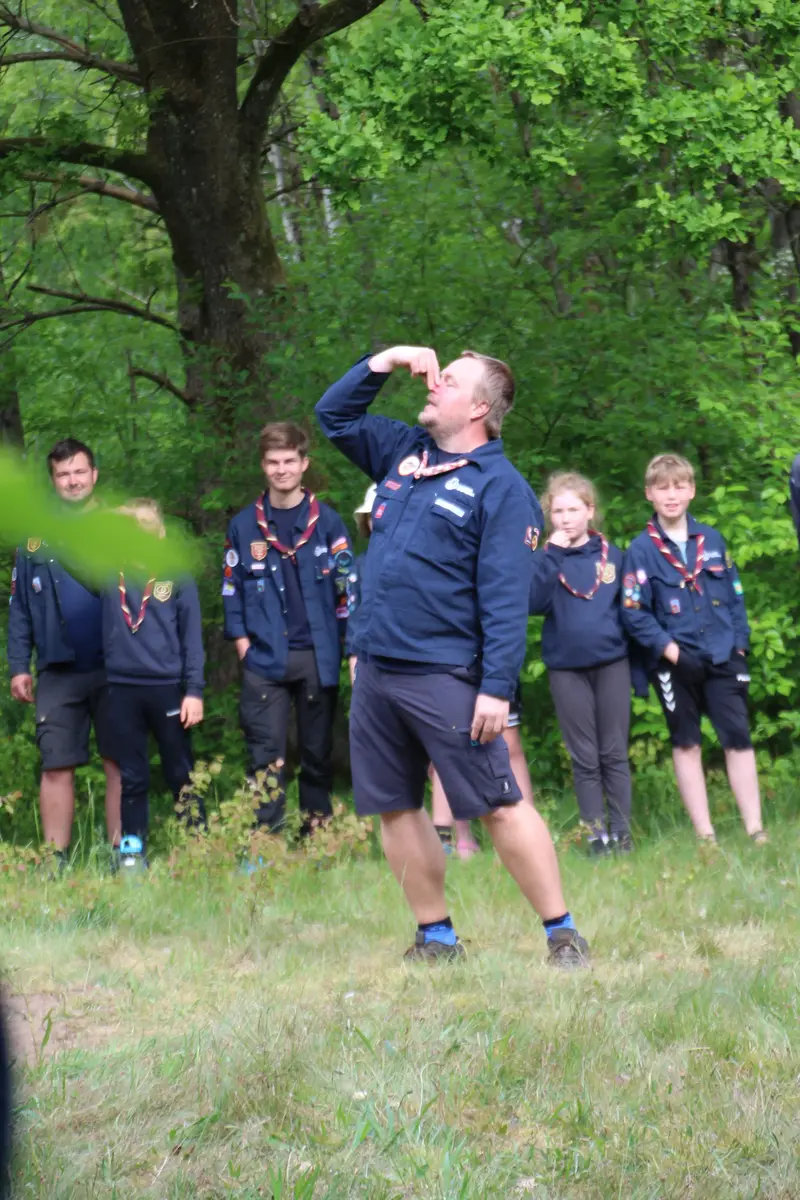 A guy holding his nose in front of an audience