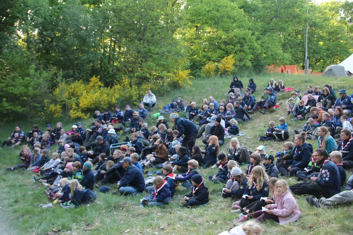 A bunch of people cozying up under blankets in the wilderness