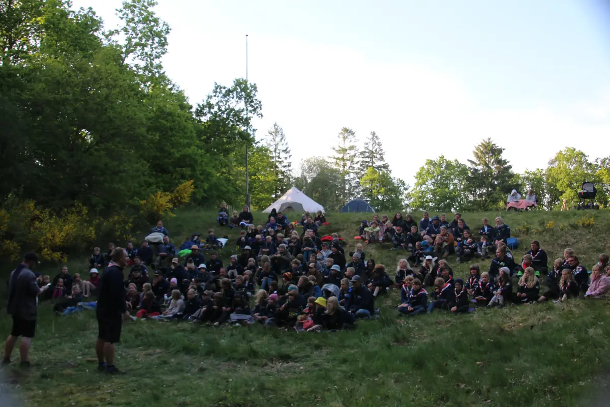 A bunch of people cozying up under blankets in the wilderness