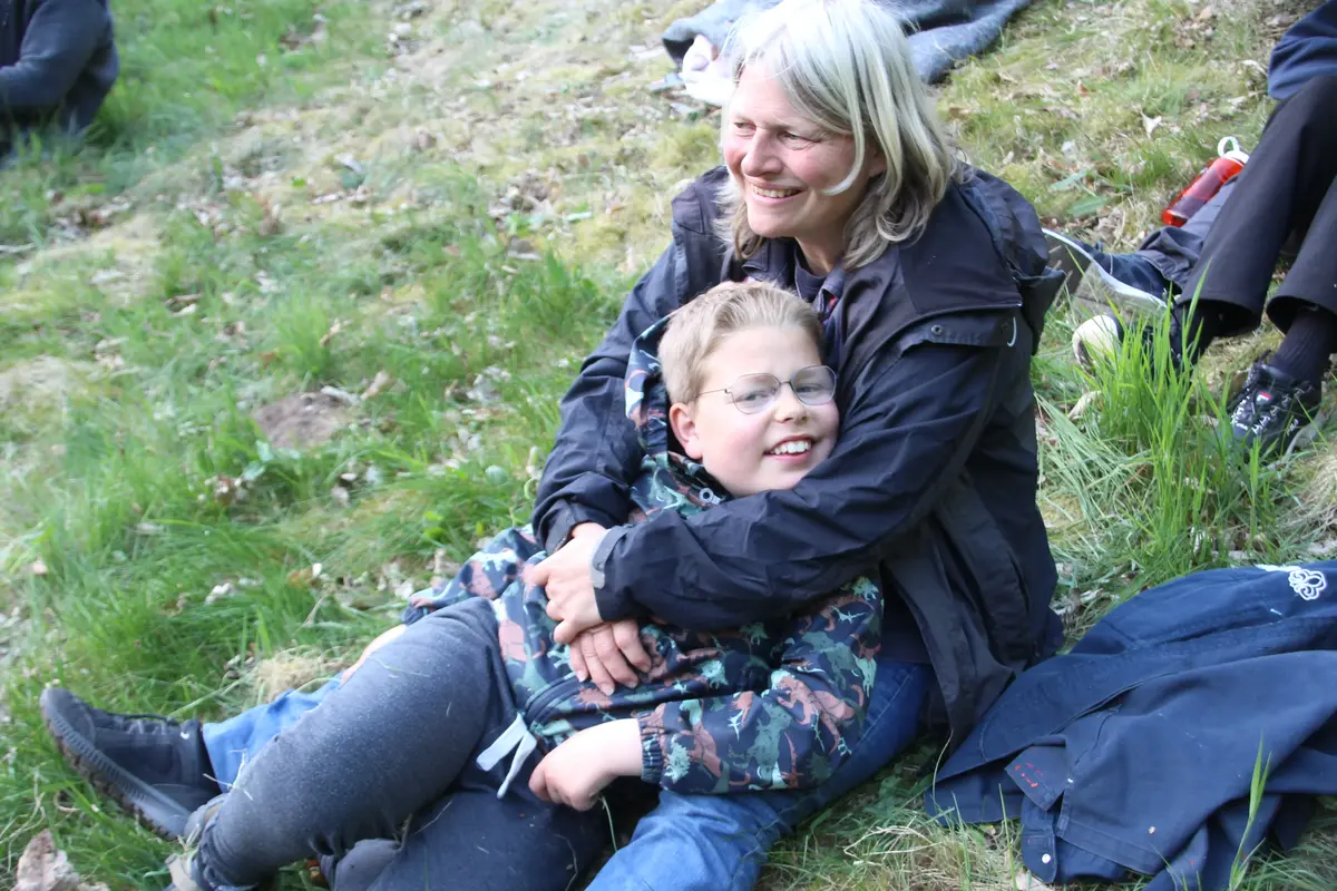 A kid cozying up to a woman