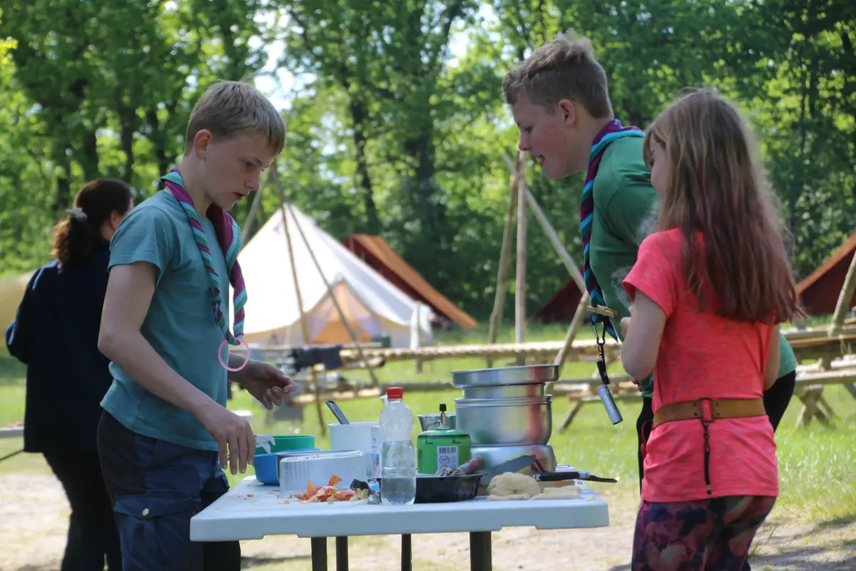 A couple of kids making food