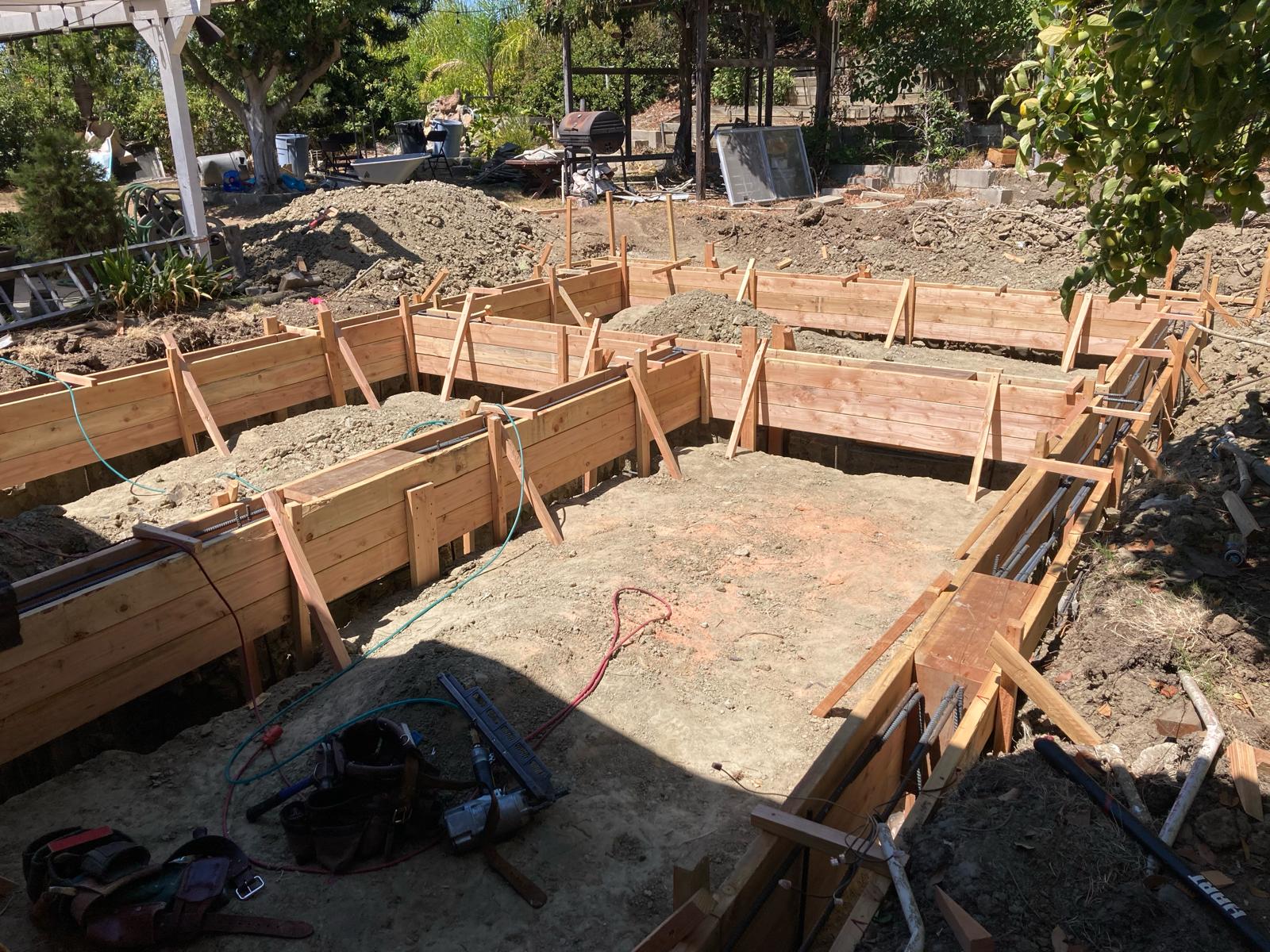 Construction site showing wooden concrete forms and foundation framework for new home building project