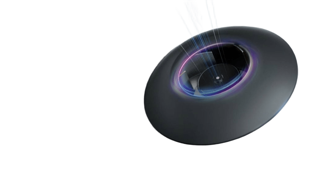 Young woman with brown hair in a ponytail wearing a white turtleneck standing in front of a green upholstered modern chair.