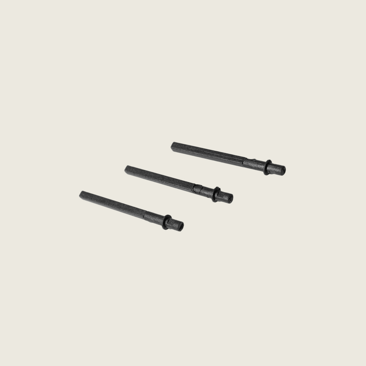 Three identical black plastic injection molded rods with hexagonal ends and a round flange near one tip, isolated on a light background.