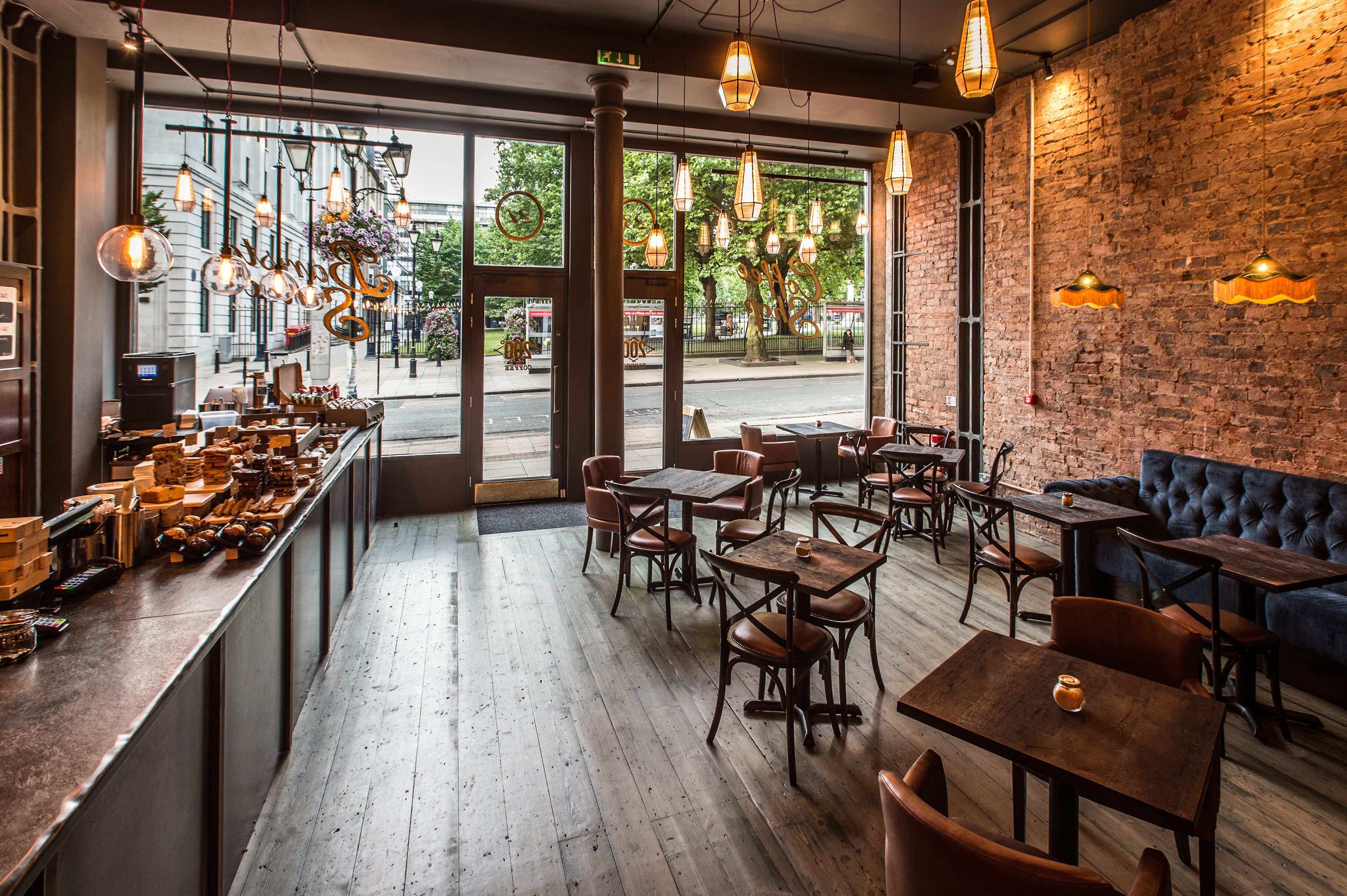 Crowd of people walking across a bridge decorated with colorful flags and a large Sziget Island of Freedom sign.