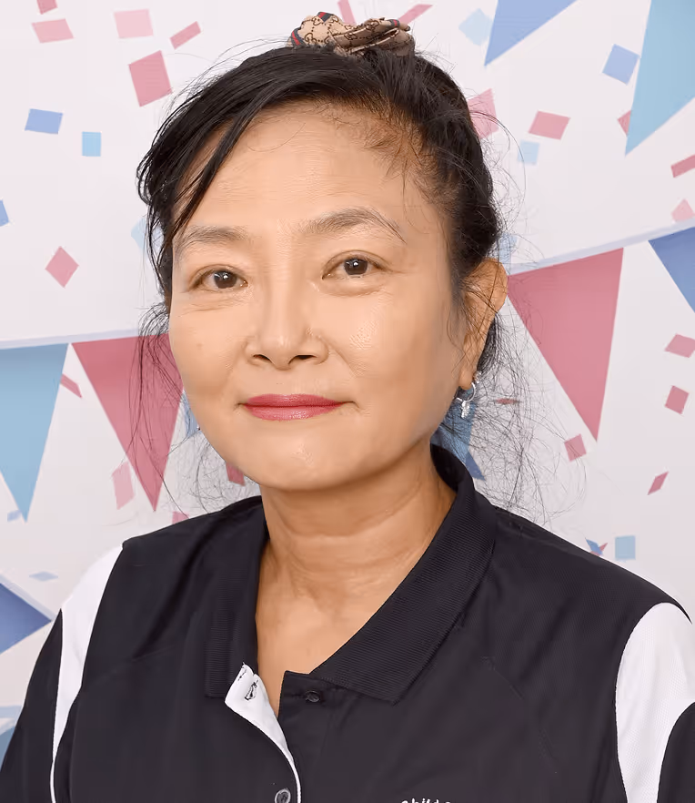 Portrait of Miss Linda Director, ECT wearing a black and white collared shirt, with a festive background of colorful triangular flags and confetti.