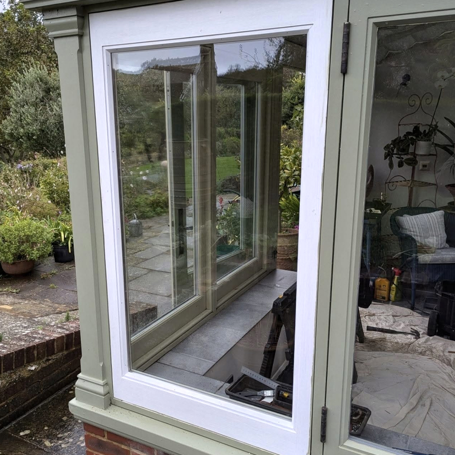 A white window made of wood frame around glass. Designed and created by RGM Joinery