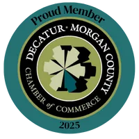 Seal of Decatur-Morgan County Chamber of Commerce with 'Proud Member 2025' text in teal circle.