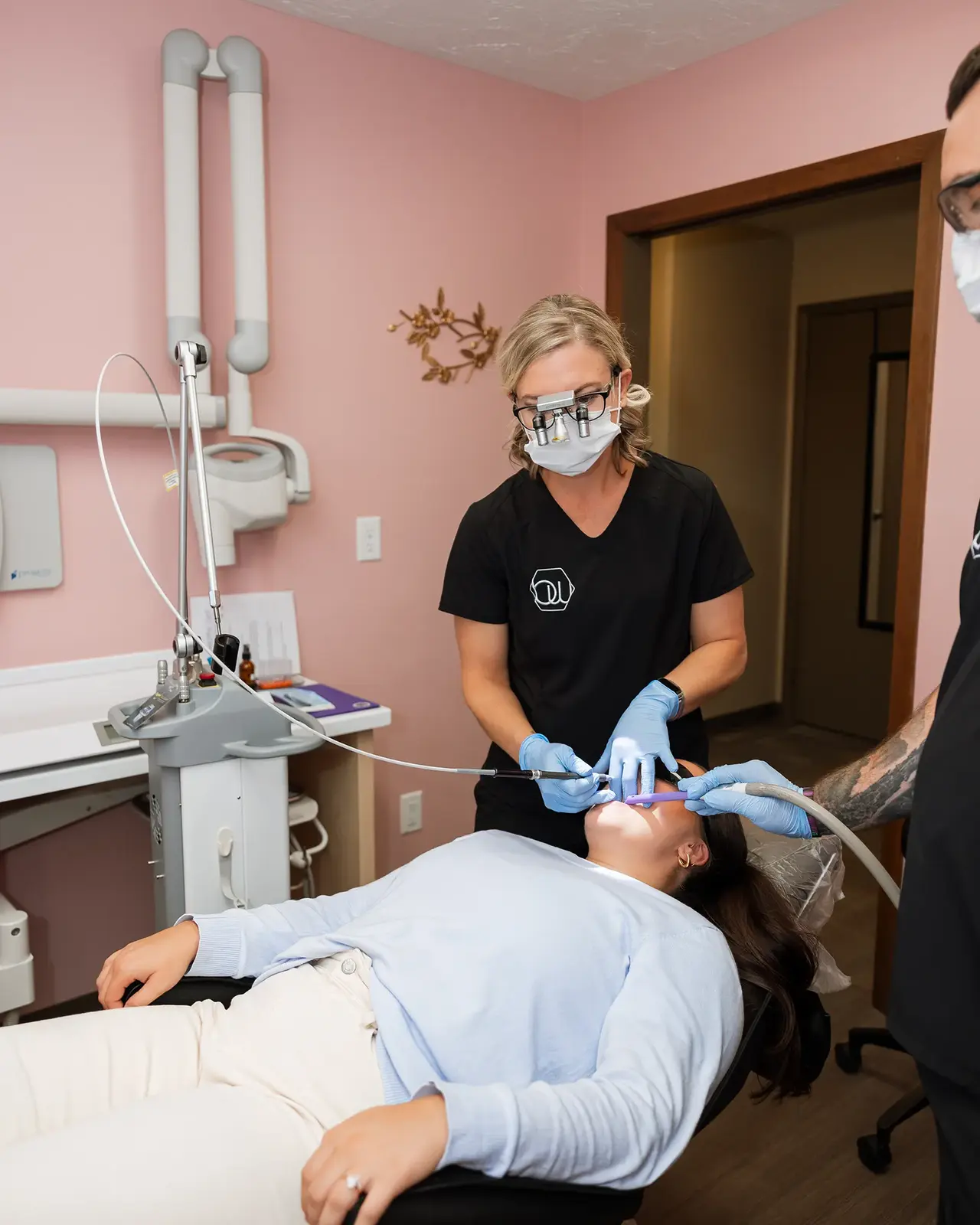 Dentist performing a gentle tongue and lip tie exam on a young child at Brite White Dental in Manton, MI