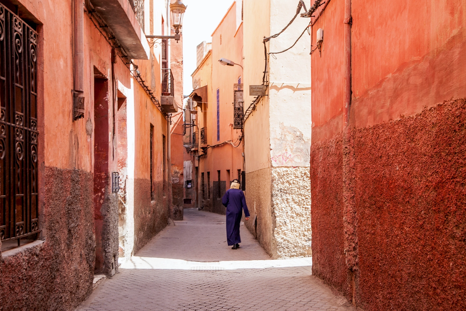 A quiet Marrakech medina lane at early morning light.