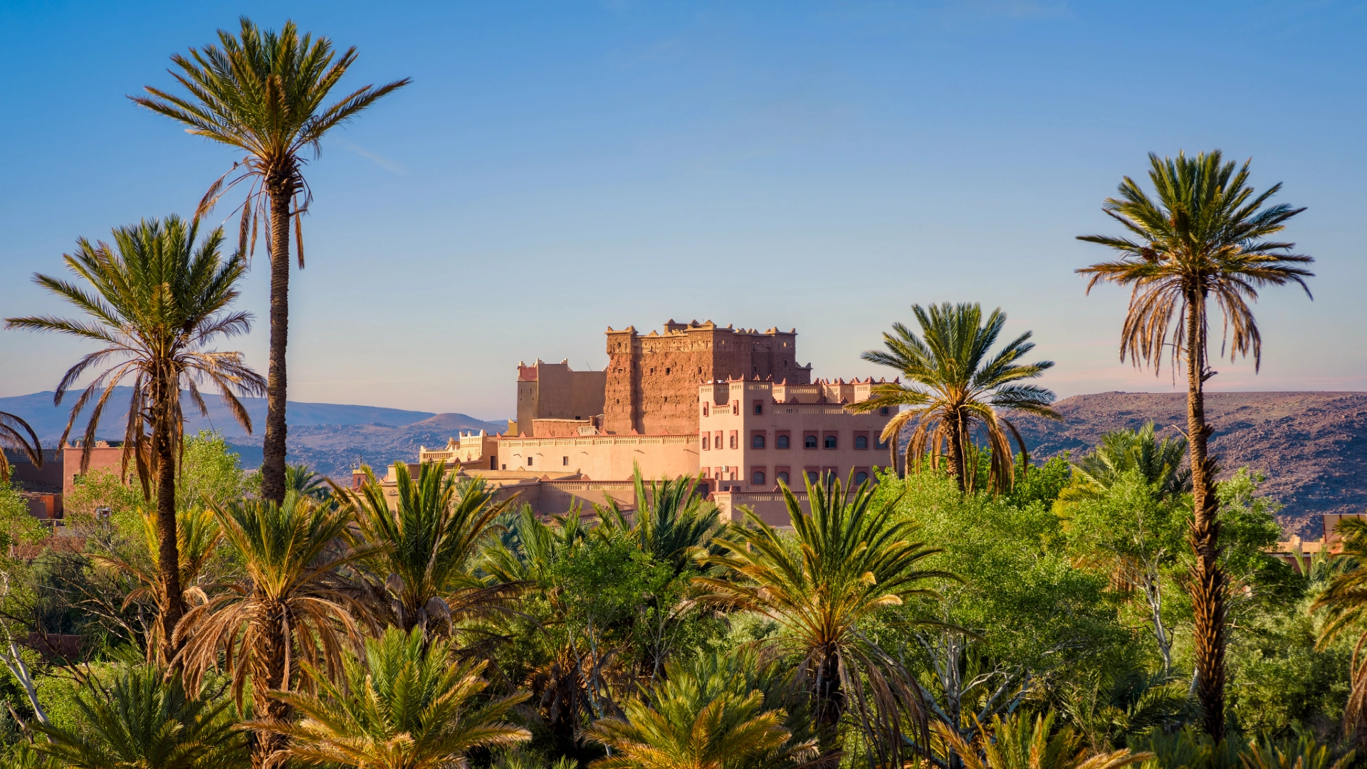 Earthen Kasbah Tiout rising above a palm grove near Taroudant, Morocco