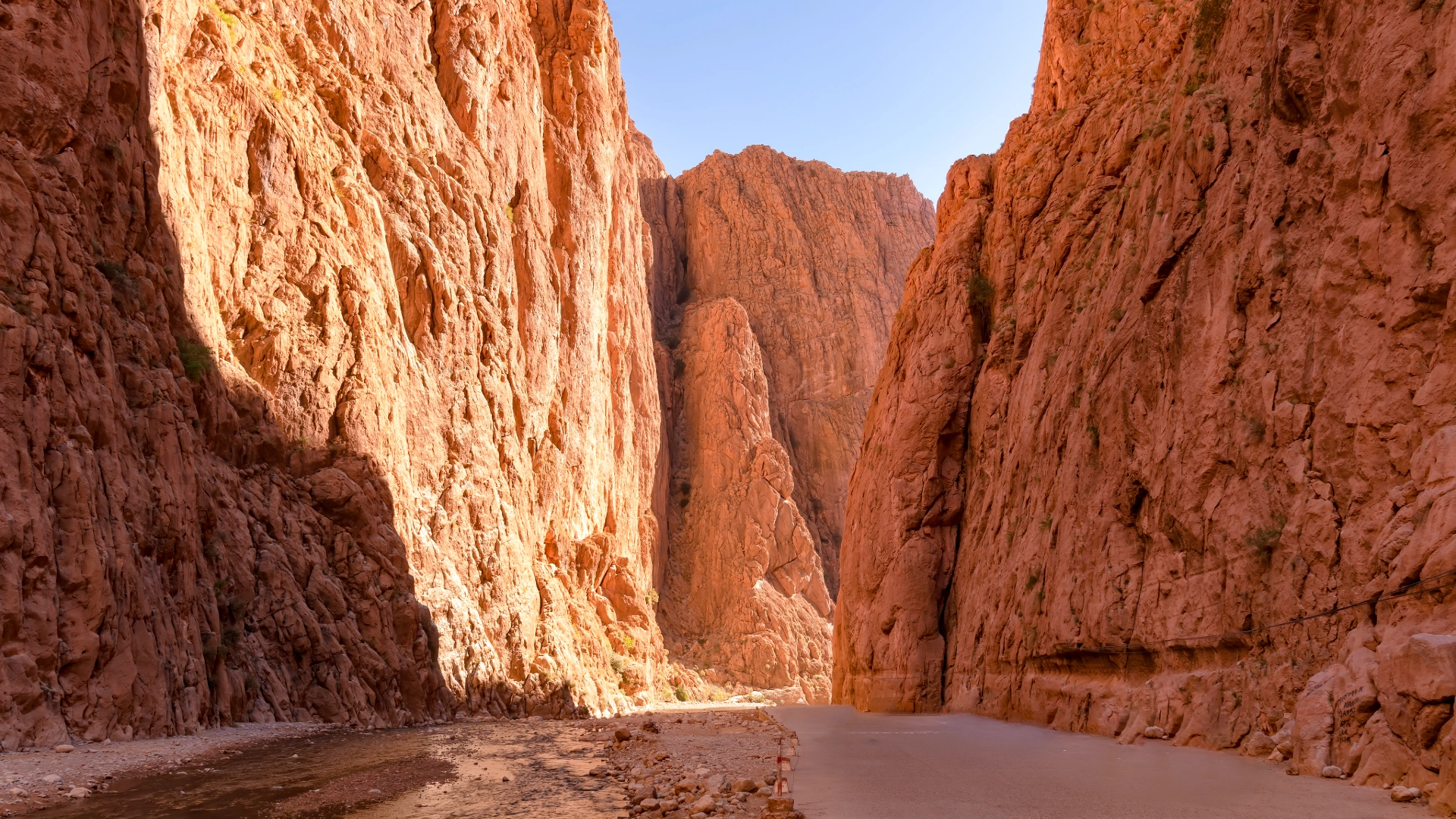 Narrow road passing between the towering rock walls of Todra Gorge, Morocco