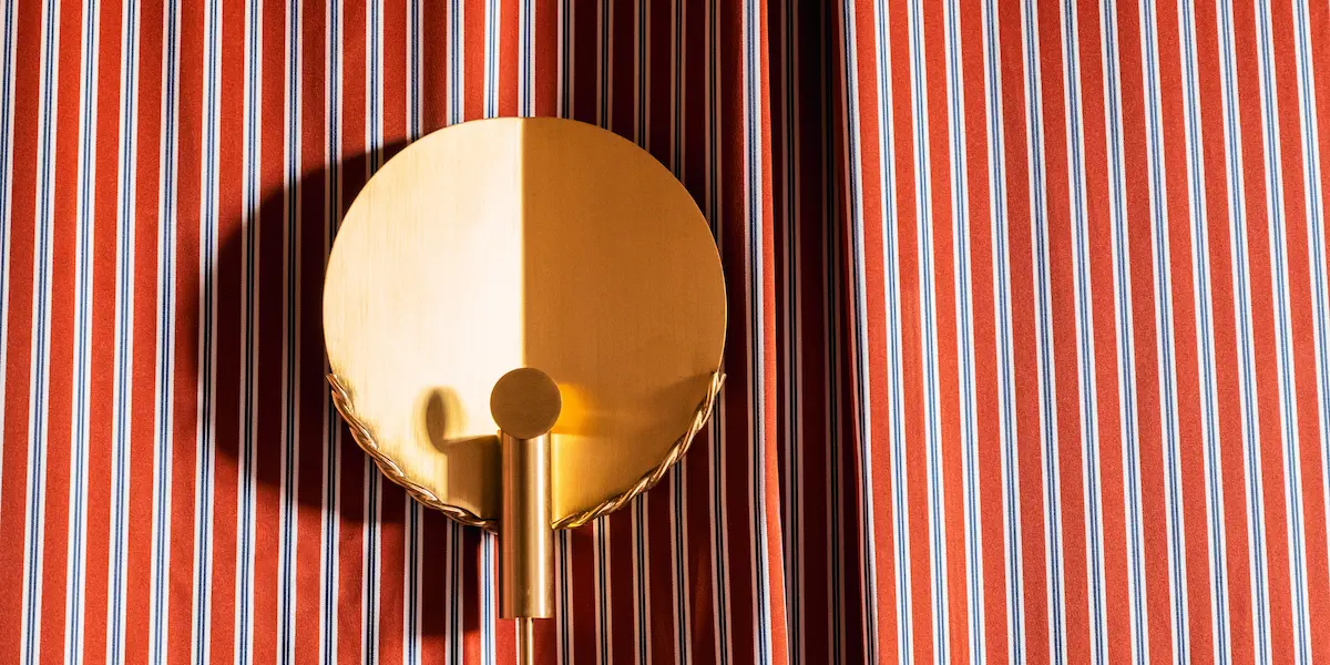 Interior space at Experimental Roma with built-in storage, television and decorative objects.