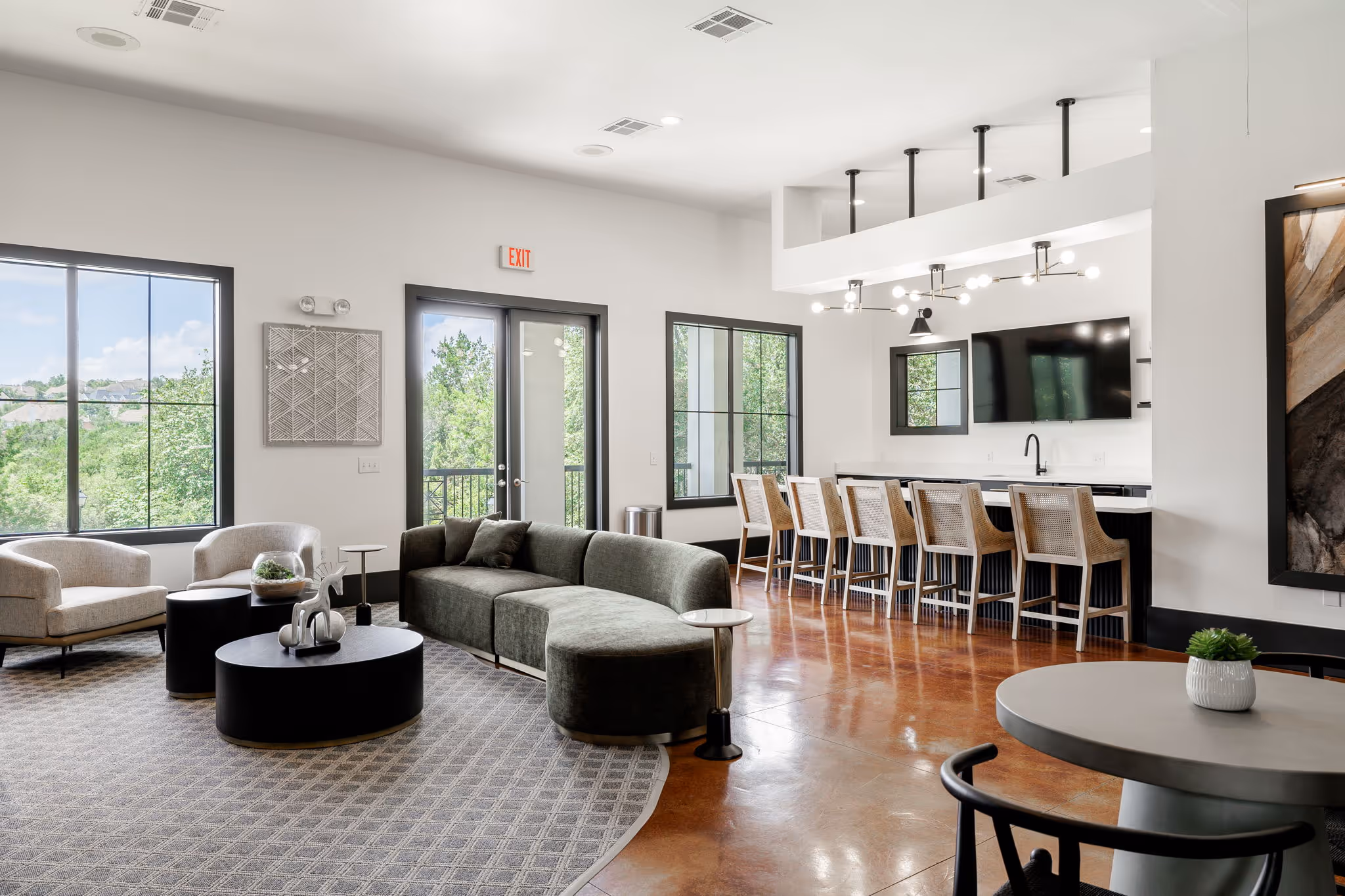 Community kitchen seating area with bar and tables, chairs, and sofas
