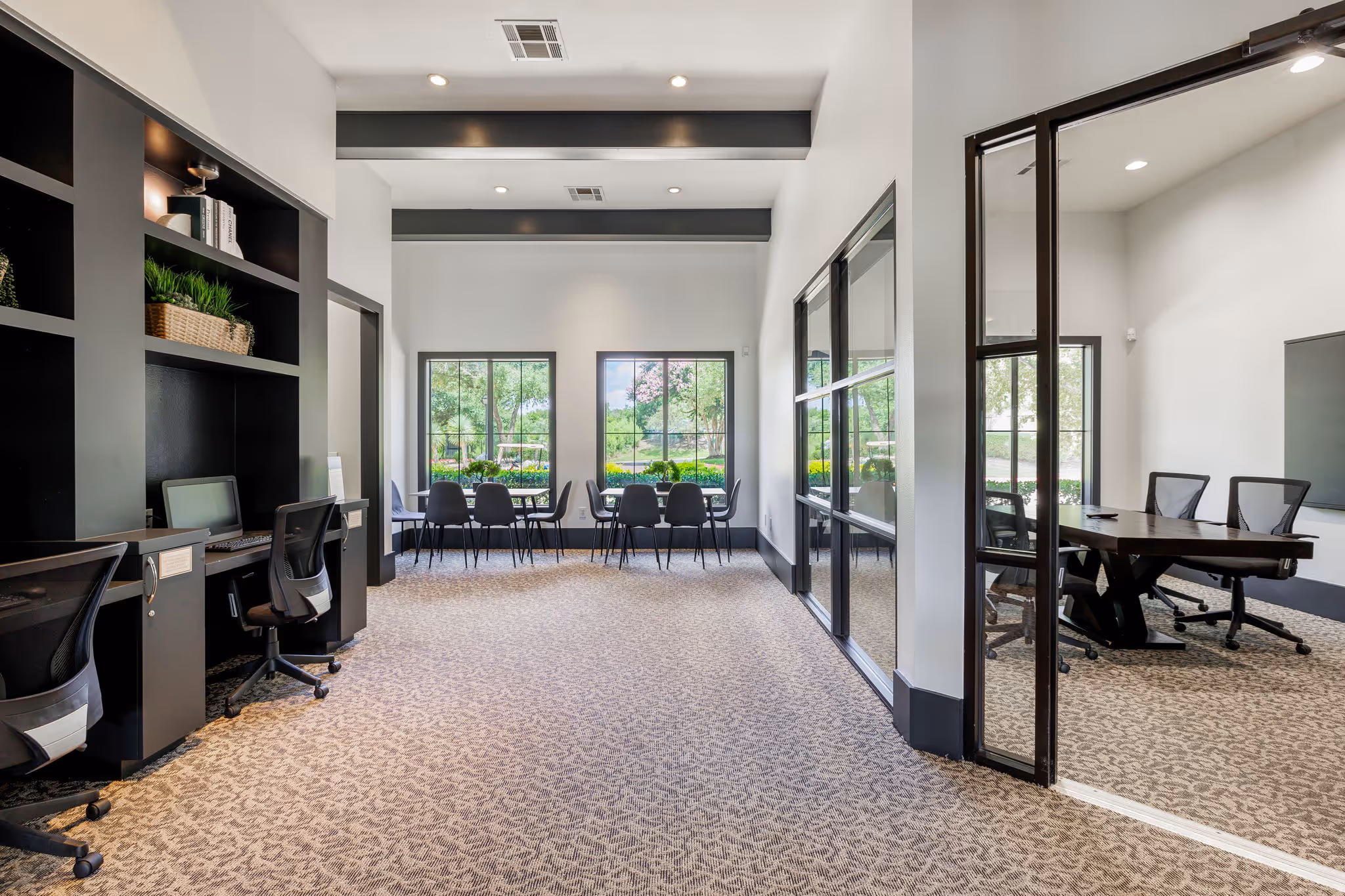 business center with desks, chairs, and computers