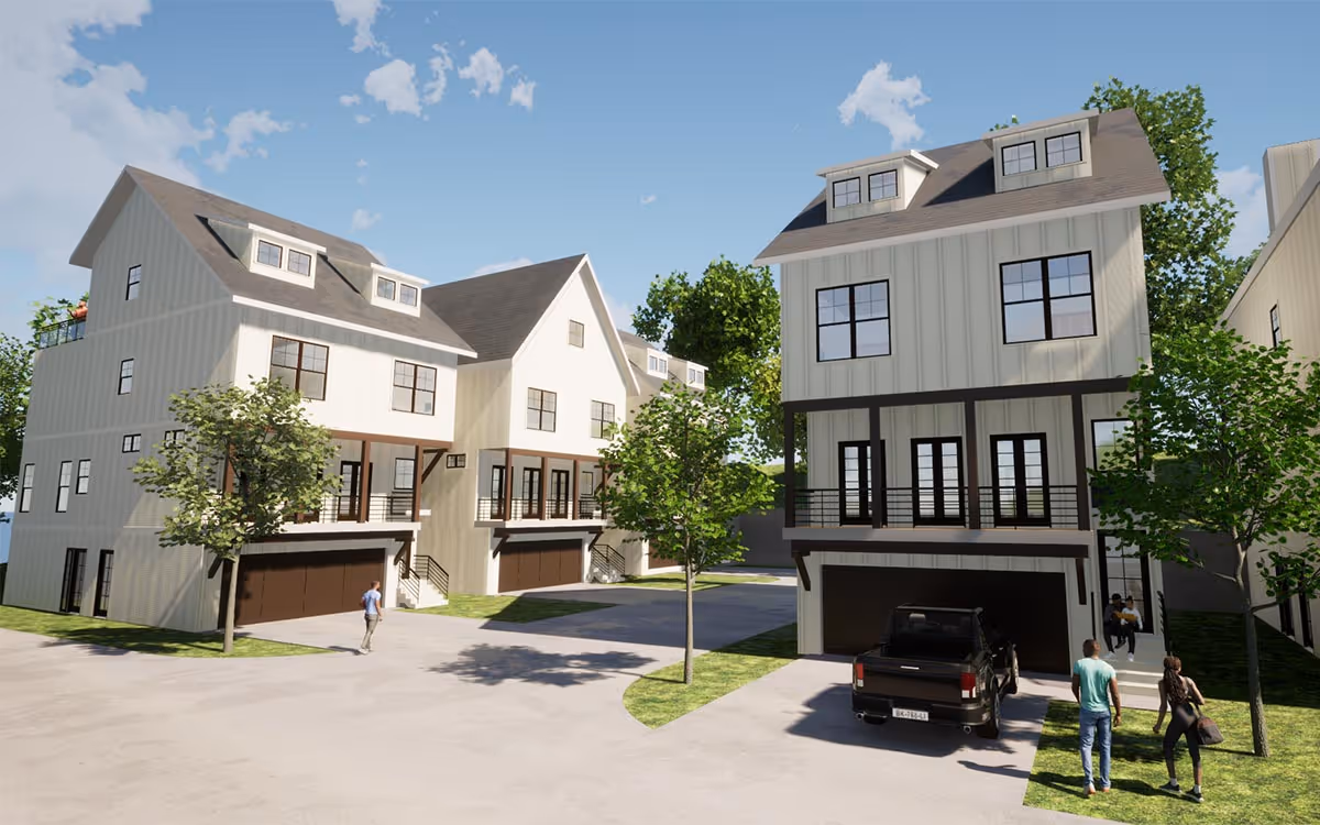 Modern three-story townhouses with large windows, garages, and trees in a sunny suburban setting.