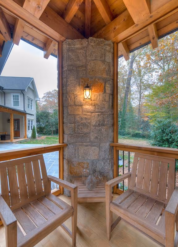 Modern bathroom with double sinks, large mirrors, chrome faucets, a potted plant, and an entrance to a walk-in closet.