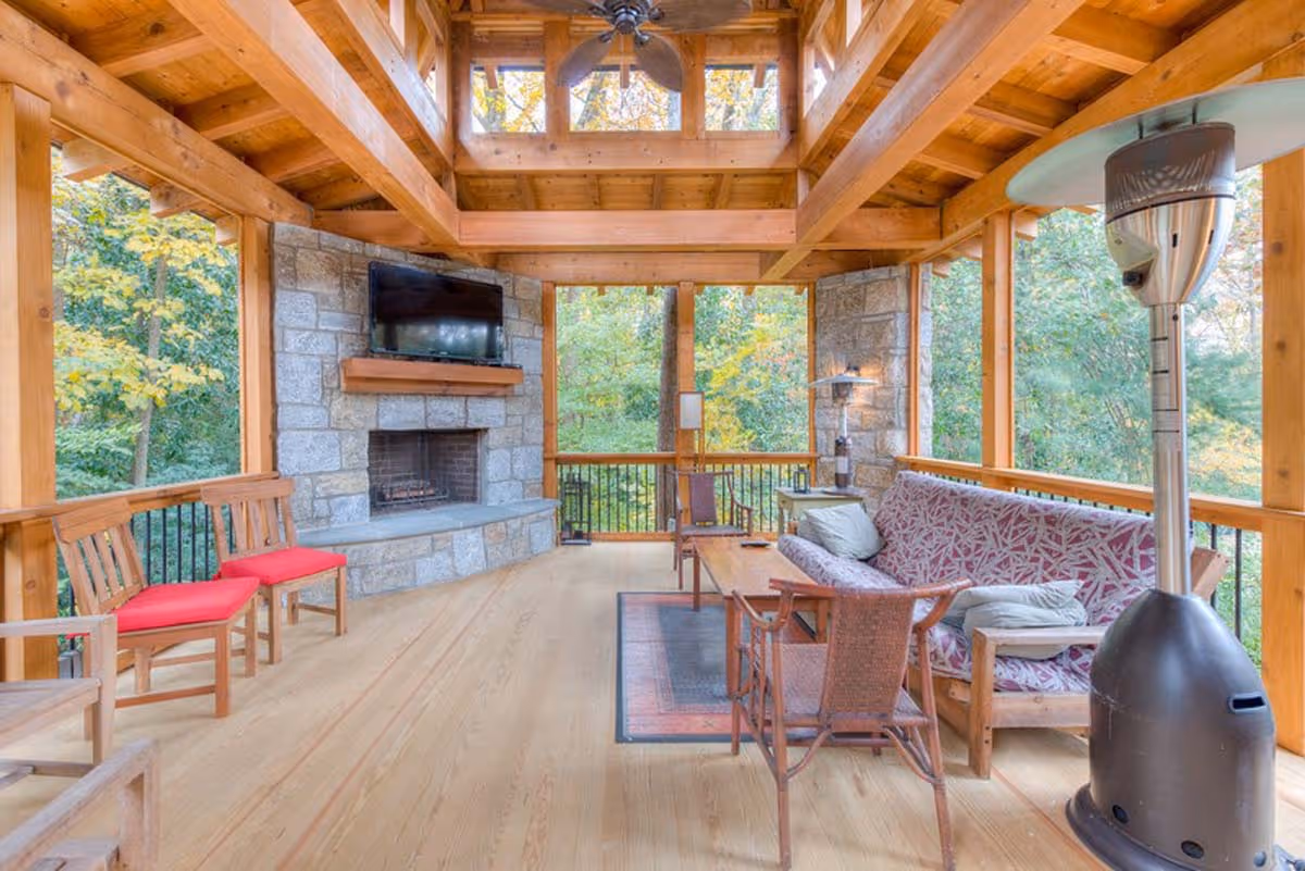 Boutique interior featuring shelves with beauty products, floral arrangements on round tables, wicker chairs, and decorative art on pink patterned walls.