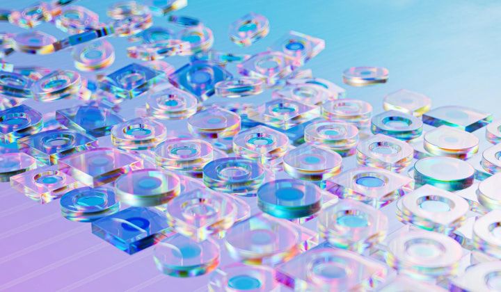 Abstract array of translucent, multicolored circular and square shapes arranged on a pastel blue and purple gradient surface.