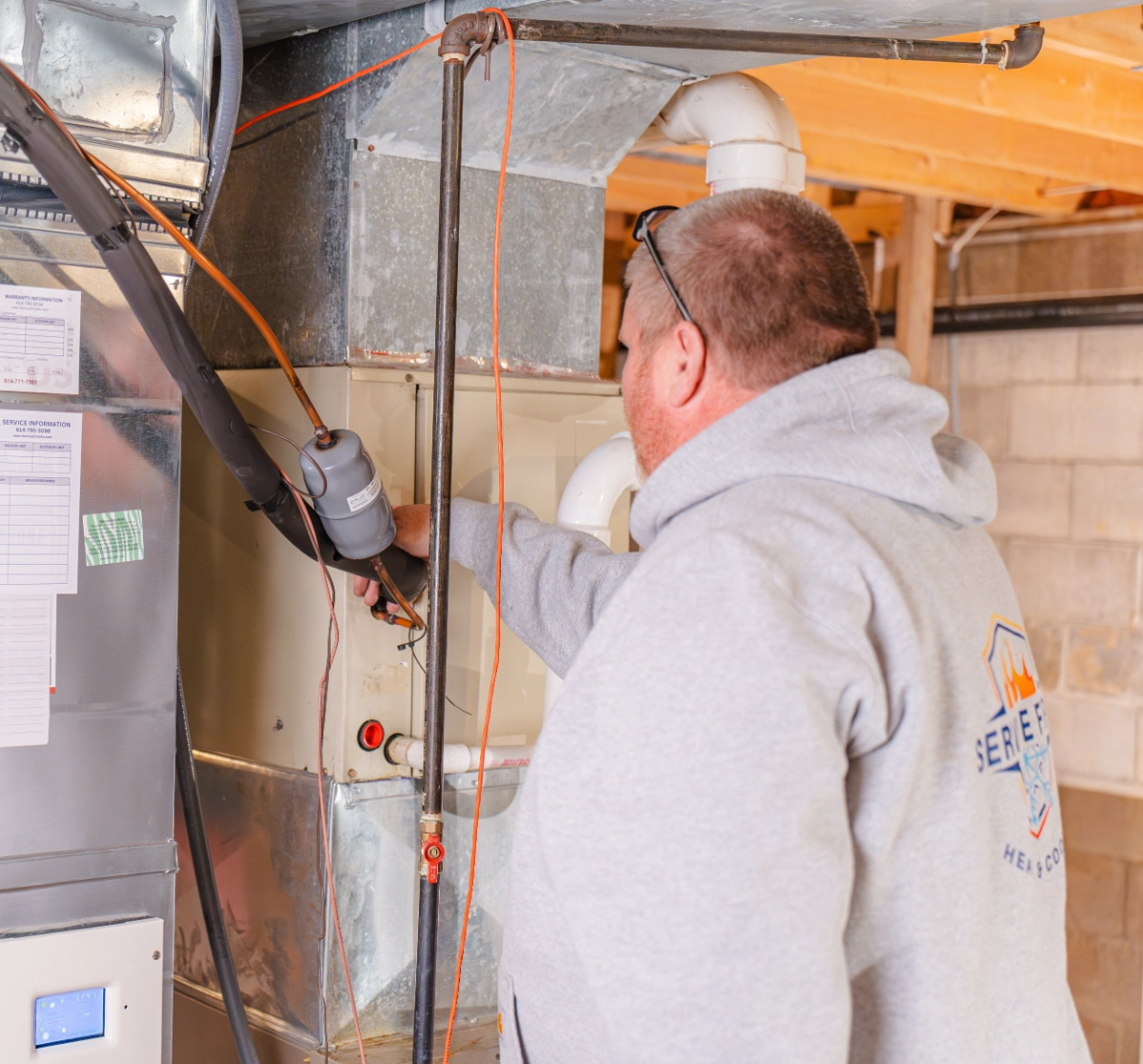 hvac technician looking at a frozen evaporator coil