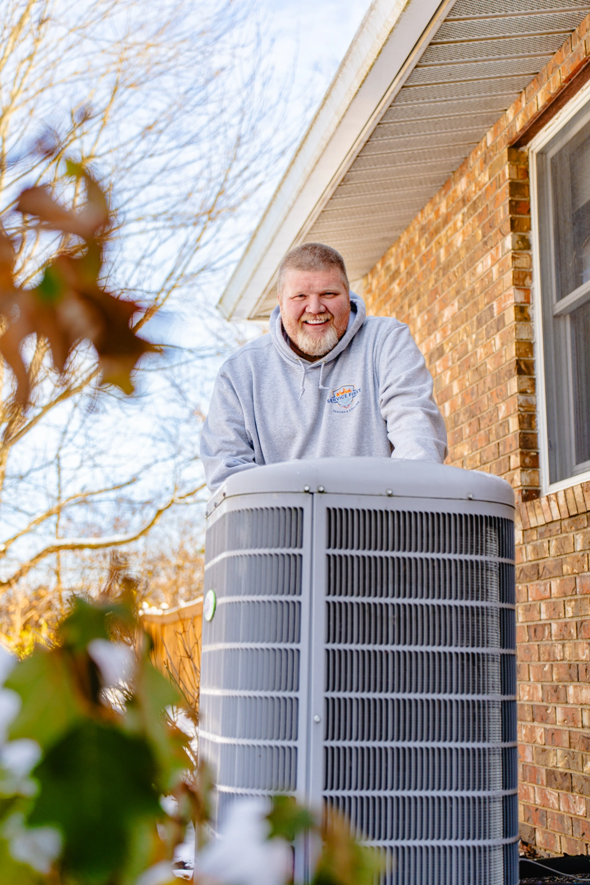 hvac tech looking at frozen air conditioner