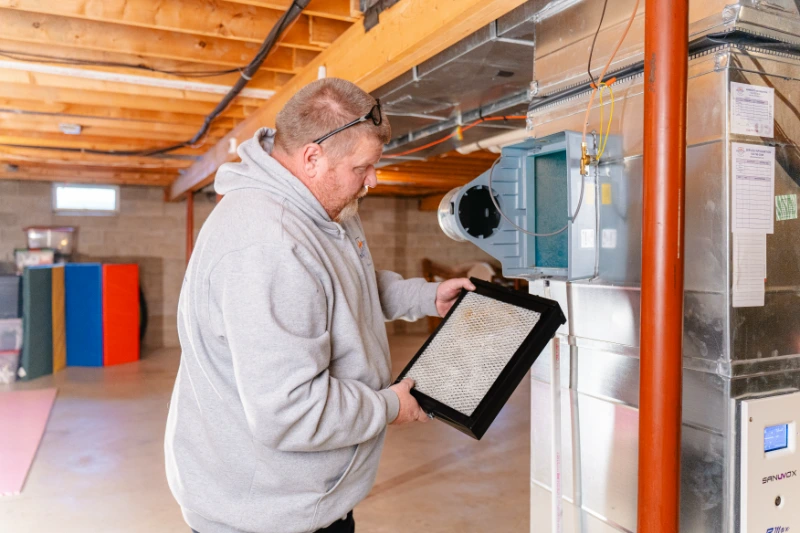 an hvac technician examining a filter for mildew