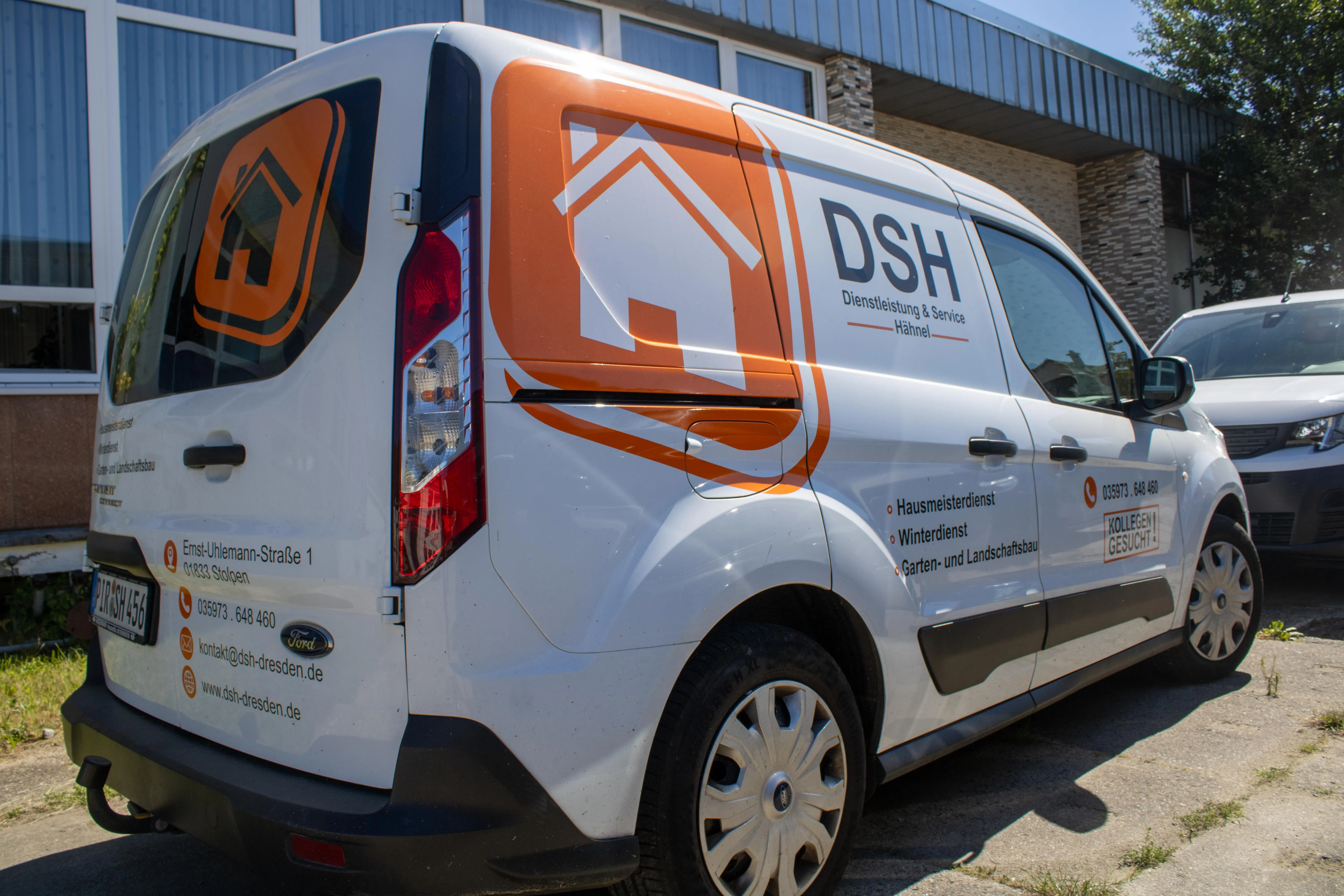 White Ford service van with orange house logo and DSH Dienstleistung & Service Hähnel branding parked outside a building.