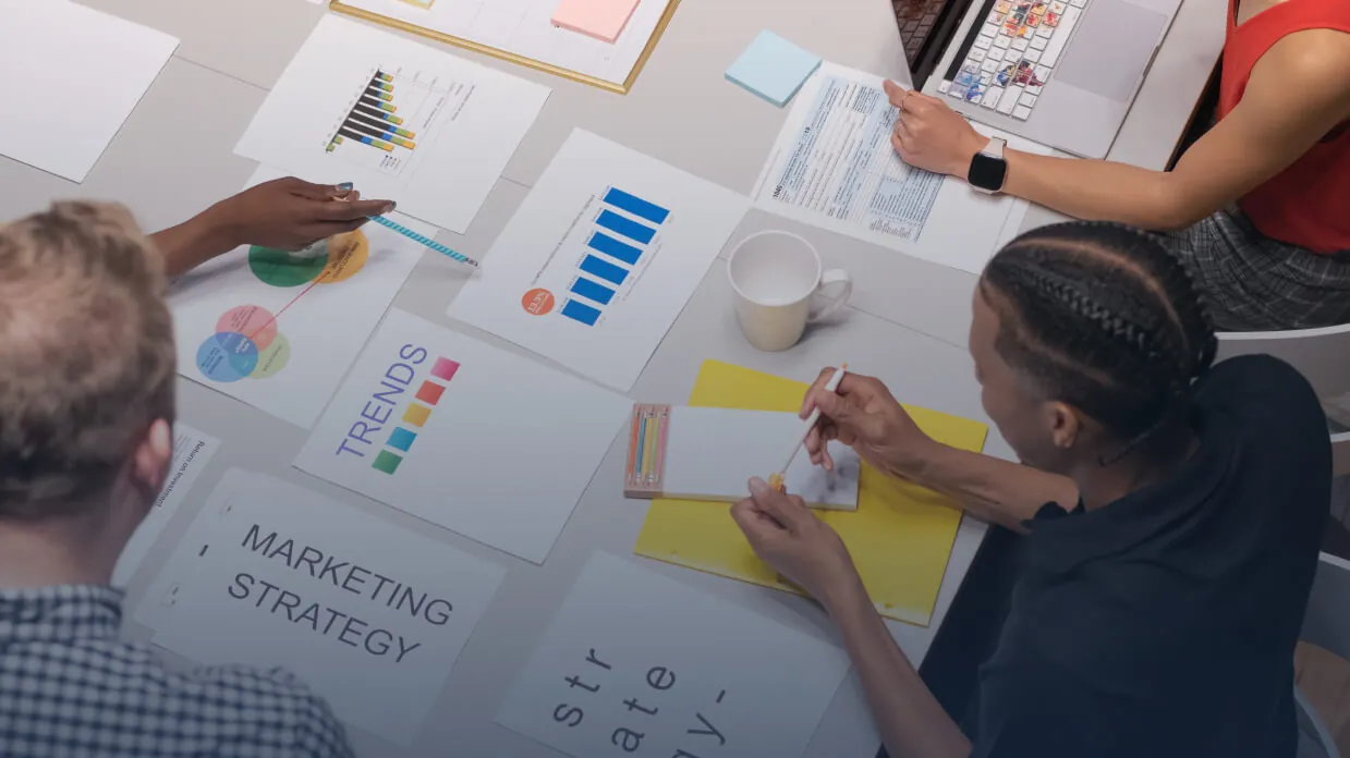A team planning a marketing strategy around printed charts