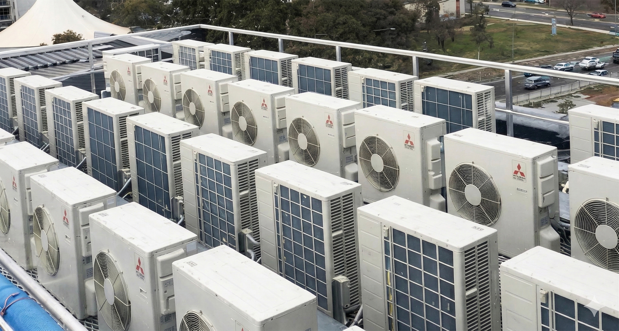 Multiple air conditioning outdoor units installed on a commercial rooftop.