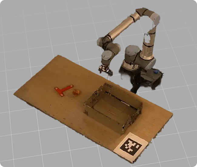 Robotic arm positioned above a wooden platform with a small box, a wrench, an orange circular object, and a black and white marker on the corner.